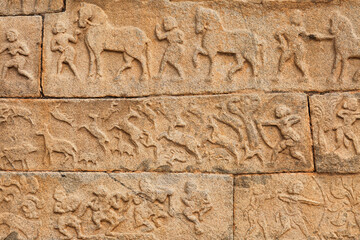 Intricate stone carvings and medieval artwork on the walls of Hazara Rama temple at Hampi, Karnataka, India