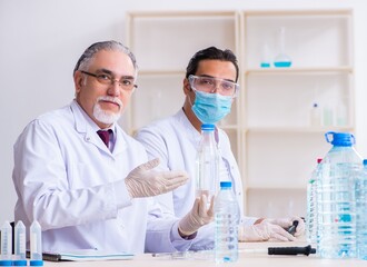 Two chemists working in the lab
