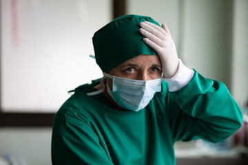 Fototapeta na wymiar Overworked female doctor surgeon in depression is tired and sad.