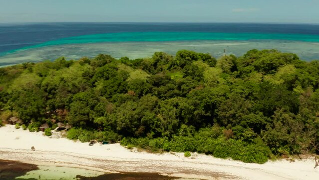 Beautiful beach on tropical island surrounded by coral reef, top view. Mantigue island. Small island with sandy beach. Summer and travel vacation concept, Camiguin, Philippines, Mindanao