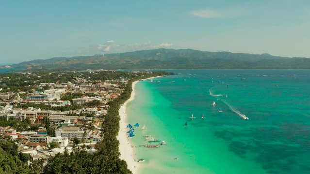 Tropical white sand beach, hotels near the blue lagoon and corall reef. aerial view, Boracay, Philippines. Seascape with beach on tropical island. Summer and travel vacation concept.