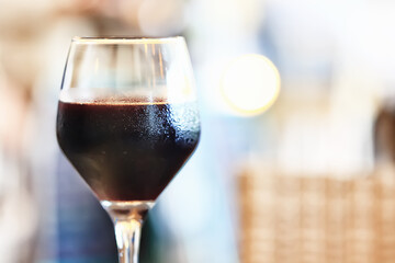 a glass of red wine in a luxurious background restaurant