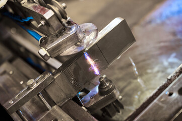 Gas cutting machine operates with metal block in workshop