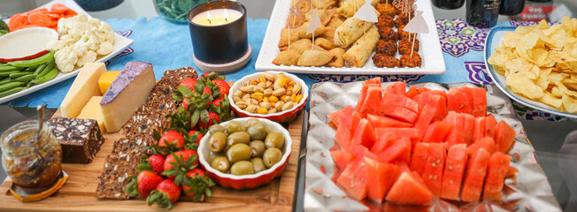 elegantly arranged charcuterie board displaying various meats, cheeses, fruits, and nuts. It symbolizes the joy of abundance and shared experiences, emphasizing the importance of enjoying life