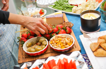 elegantly arranged charcuterie board displaying various meats, cheeses, fruits, and nuts. It symbolizes the joy of abundance and shared experiences, emphasizing the importance of enjoying life