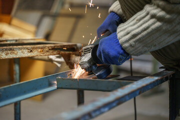 Work with a grinding machine. Sparks from the angle grinder.