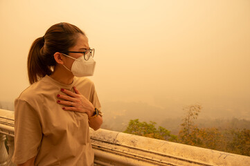 Asian woman having respiratory allergy caused of by Bad air pollution (PM2.5). PM2.5 levels meaning...