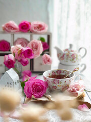 Fototapeta na wymiar Herbal tea with roses on white wooden table