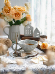 Herbal tea with roses on white wooden table