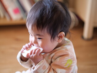 Photo of a 0-Year-Old Girl Enjoying Rice Crackers Snacks