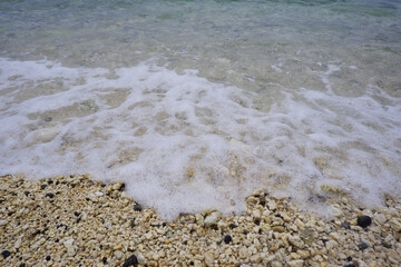 Sandy beach and natural blue ocean wave. Seaside wave closed up view.