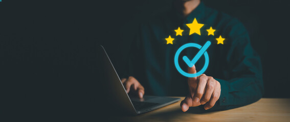 Businessman working on computer and showing the sign top Quality Assurance Standard Assurance ISO...