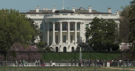 South View Of White House In Washington D.C. With Tourists Walking In Front, Seen From Ellipse Lawn