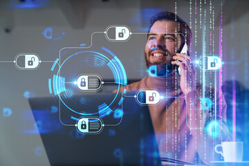 Handsome businessman working on laptop at office workplace in background. Using phone to read text, and send messages. Concept of business education, blockchain cryptocurrency technology.