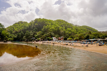 Yogyakarta, Indonesia March 2017 : Baron beach is filled with fishing boats parked in the dunes and visitors who enjoy the atmosphere of the beach.