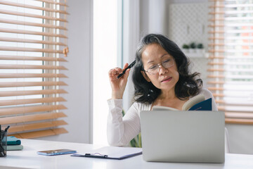 Portrait of a Senior businesswoman entrepreneur working remotely from her home office.