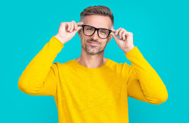 photo of cheerful man look in eyewear. man look in eyewear isolated on blue.