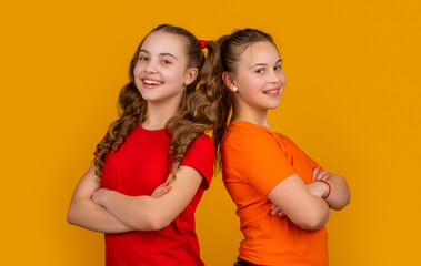 happy teen girls on yellow background. childhood
