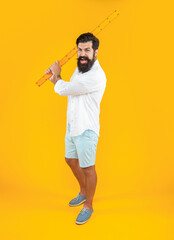 aggressive man with measuring ruler in studio. man with measuring ruler on background.