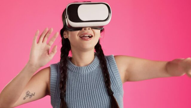 Vr headset, 3d metaverse and woman with cyber virtual reality in a studio with web software. Isolated, pink background and young female gamer streaming fantasy games with user interface for gaming