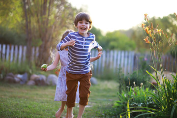 Children walk in the summer in nature. Child on a sunny spring morning in the park. Traveling with children.