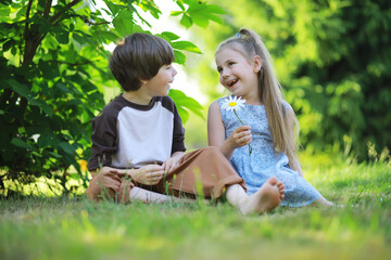 Fototapeta premium Children walk in the summer in nature. Child on a sunny spring morning in the park. Traveling with children.