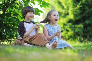 Children walk in the summer in nature. Child on a sunny spring morning in the park. Traveling with children.