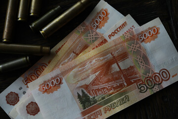 Bullets lie on the russians money money with inscription five thousands rubles top view