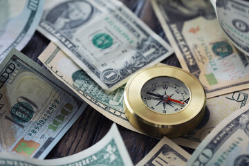 Money bill with golden Compass. Bullets and cartridge cases as a military concept. Close up US Currency and compass. business, financial idea, concept, symbol of crisis, inflation