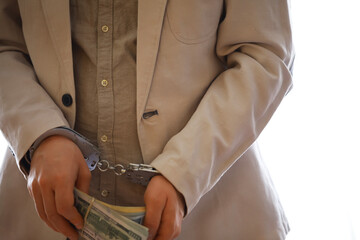 stressed out businessman hands bothered with handcuffs suffering at custody for concept of...