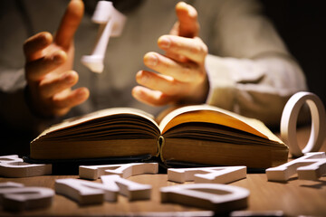 Man holding an open book with two hands. Concept of learning, education, knowledge and religion