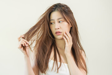 Damaged Hair, frustrated asian young woman, girl hand in holding splitting ends, messy unbrushed...