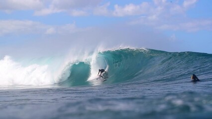 Slow Motion Shot Of Men Enjoying While Surfing On Blue Ocean Against Sky During Sunny Day - Waikiki, Hawaii