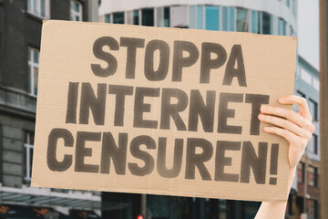 The question " Stop online censorship!" on a banner in men's hands with blurred background. Silence. Regulation. Human rights. Freedom. Free speech. Internet. Network. Violation