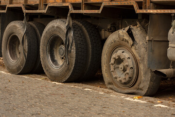 Fototapeta na wymiar 16th March, 2023, Kaziranga, Assam, India: Flat tire on the road