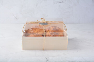 gourmet freshly bake golden Texas sweet original honey biscuit bun cake scone milk butter bread in square bento wood box on white marble table rose gold fork knife pastry halal dessert vegan menu