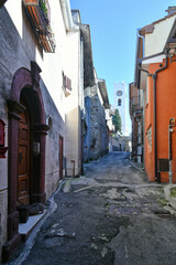 Fototapeta premium A narrow street among the old houses of Torrice, a medieval town in the province of Frosinone in Italy.