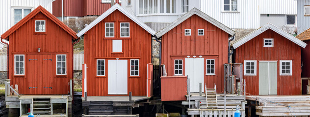 Swedish fishing village H&auml;lleviksstrand with red and white houses near the sea