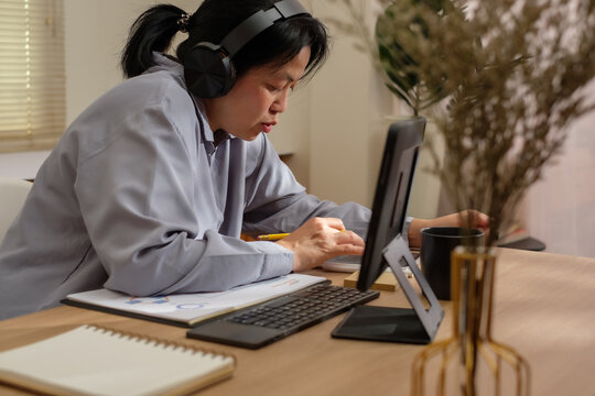asian woman using tablet when take a break from video conference meeting