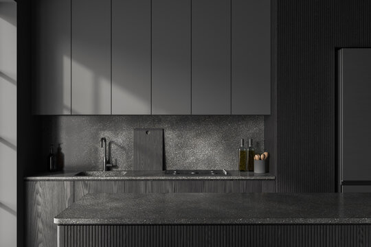 Grey kitchen interior with bar countertop and cooking space