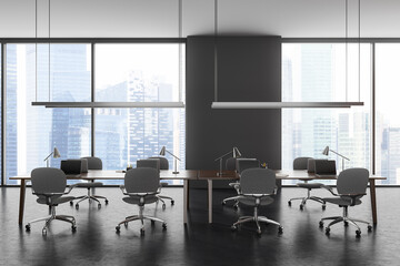 Fototapeta na wymiar Grey business workplace interior with laptop on shared desk, panoramic window