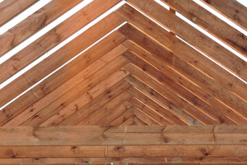 A timber roof truss of a house under construction