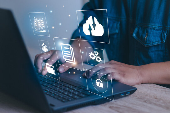 Businessman using laptop with digital graph to manage documents Online software document database and digital file storage and enterprise resource planning file access concept.