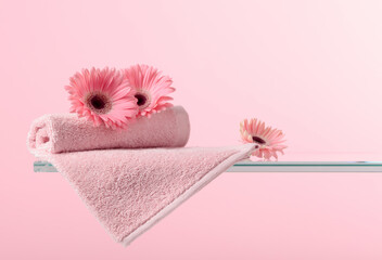 Spa composition with pink gerber and towels.