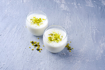 Traditional Indian lime lassi drink with dahi yogurt, lime and chopped pistachios served as...