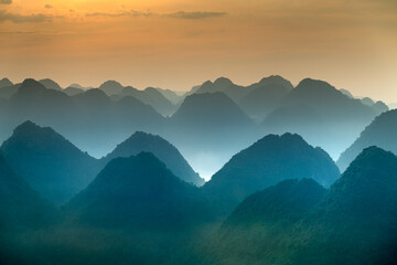 The magical scene of the mountains resemble the successive message they are covered with layers of lush green vegetation at dawn in Bac Son district Lang Son Province, Vietnam