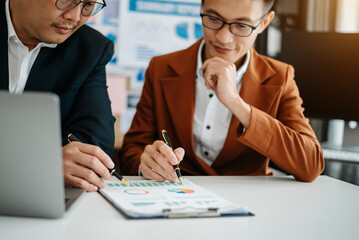 .BusinesswomanBusiness leading team meeting and using tablet and laptop computer with financial in coworking office