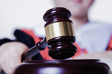 Conceptual image: One law for all. Portrait of judge (lawyer) makes a decision.  Selective focus.