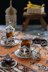 turkish tea on the table, served with date fruits, one sunnah food for breakfasting. ramadhan concept