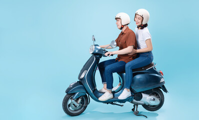 Young Asian couple ride scooter on background